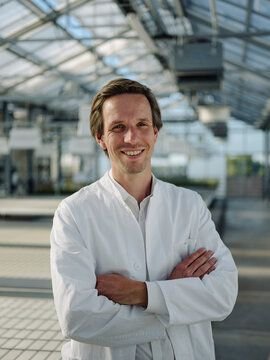 Portrait of a smiling scientist in a greenhouse Stock Photo
